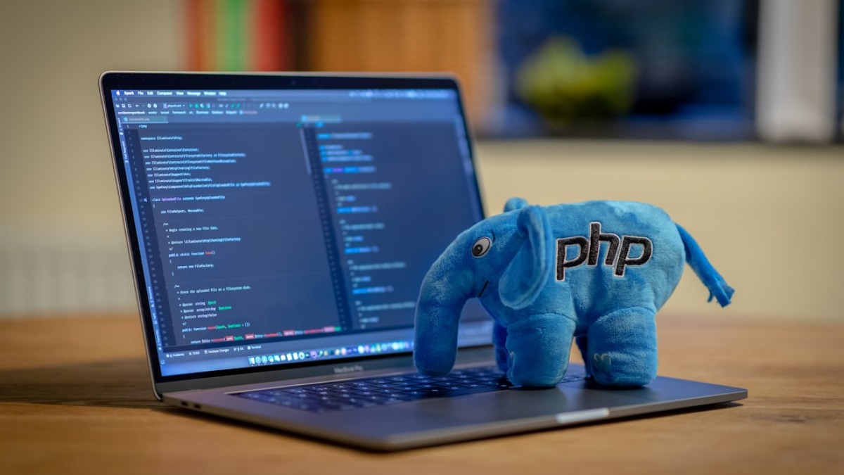 blue and white elephant plush toy on black laptop computer