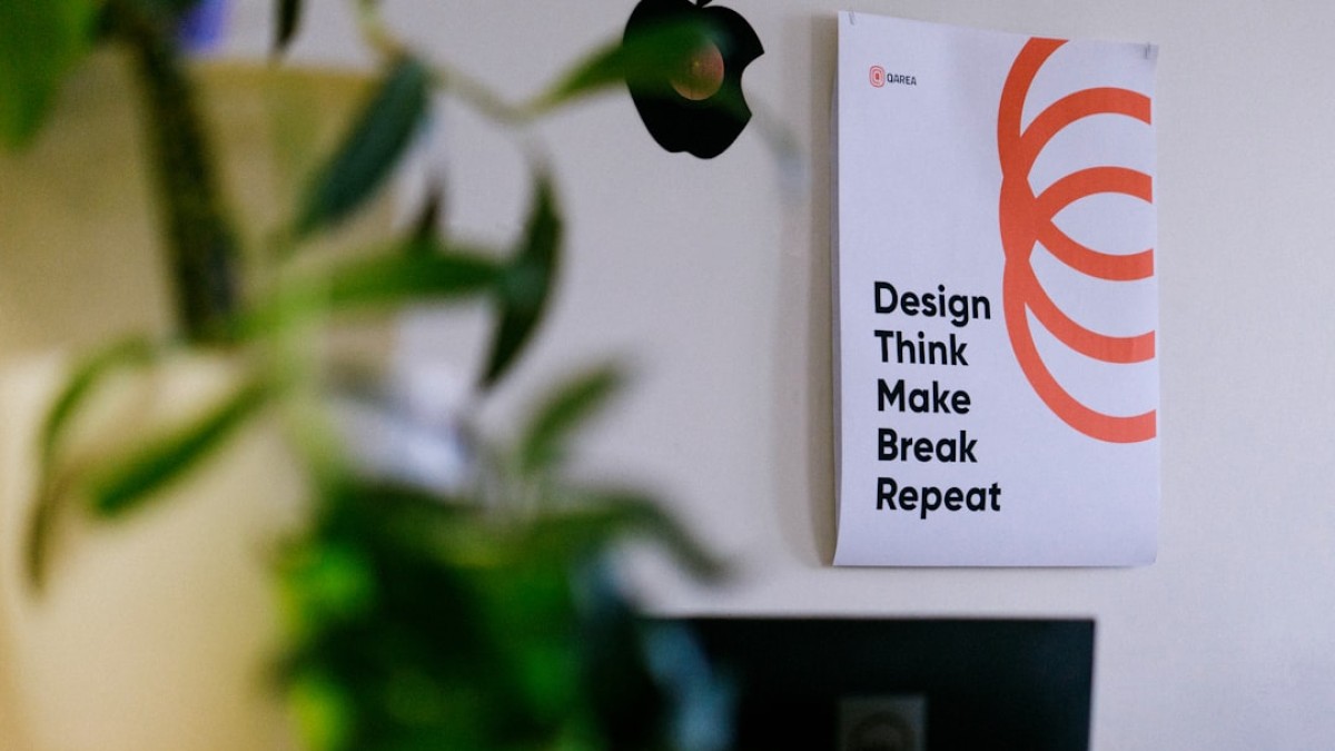 white and orange card on green plant