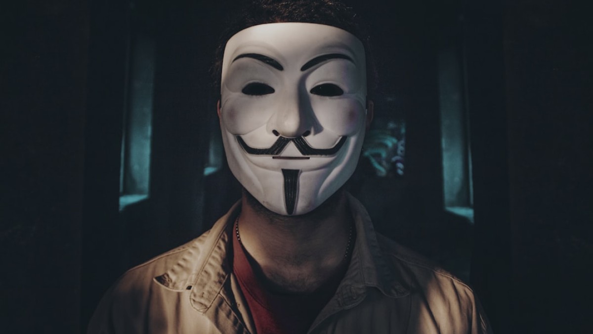 person wearing guy fawkes mask