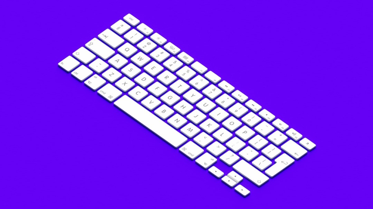 a computer keyboard on a purple background