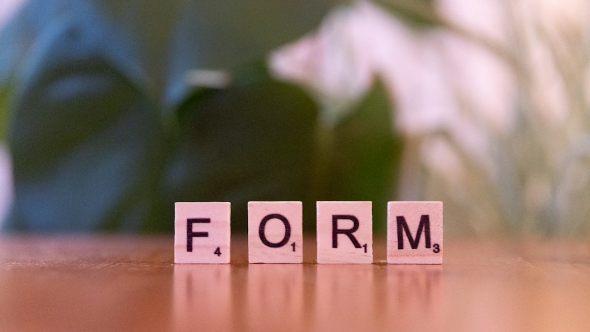 Scrabble letters spelling form on a wooden table