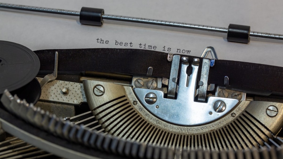 black and gray typewriter on white table