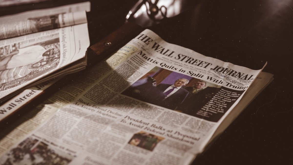 newspaper on black wooden table