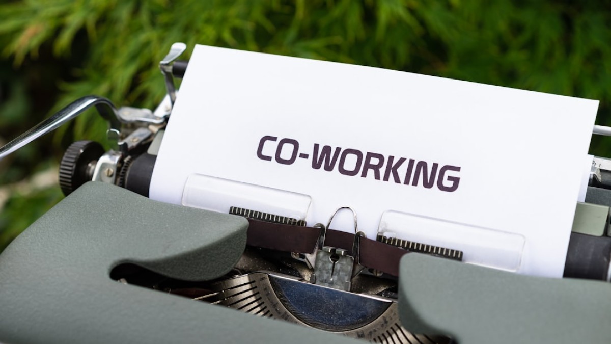 white and black typewriter on green grass during daytime